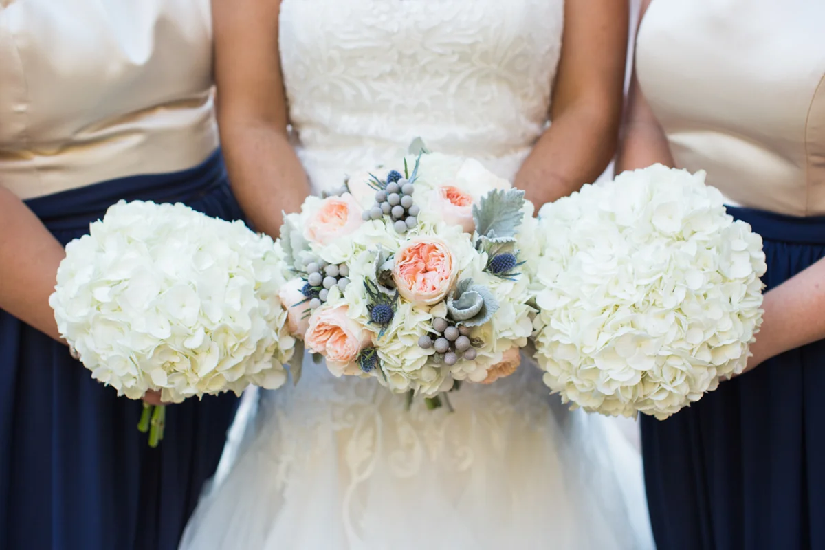 bride and bridesmaids bouquets featuring hydrangea and roses
