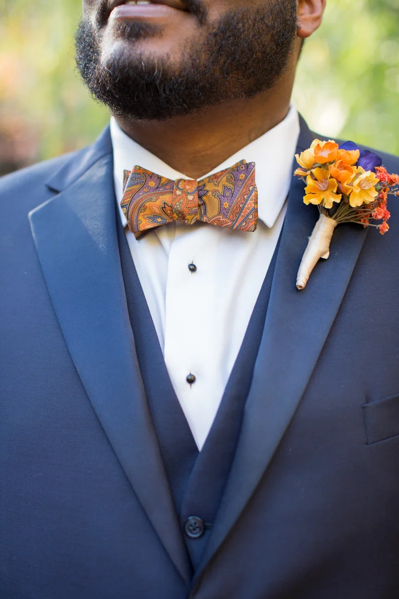 groom's orange bowtie and boutinnere details