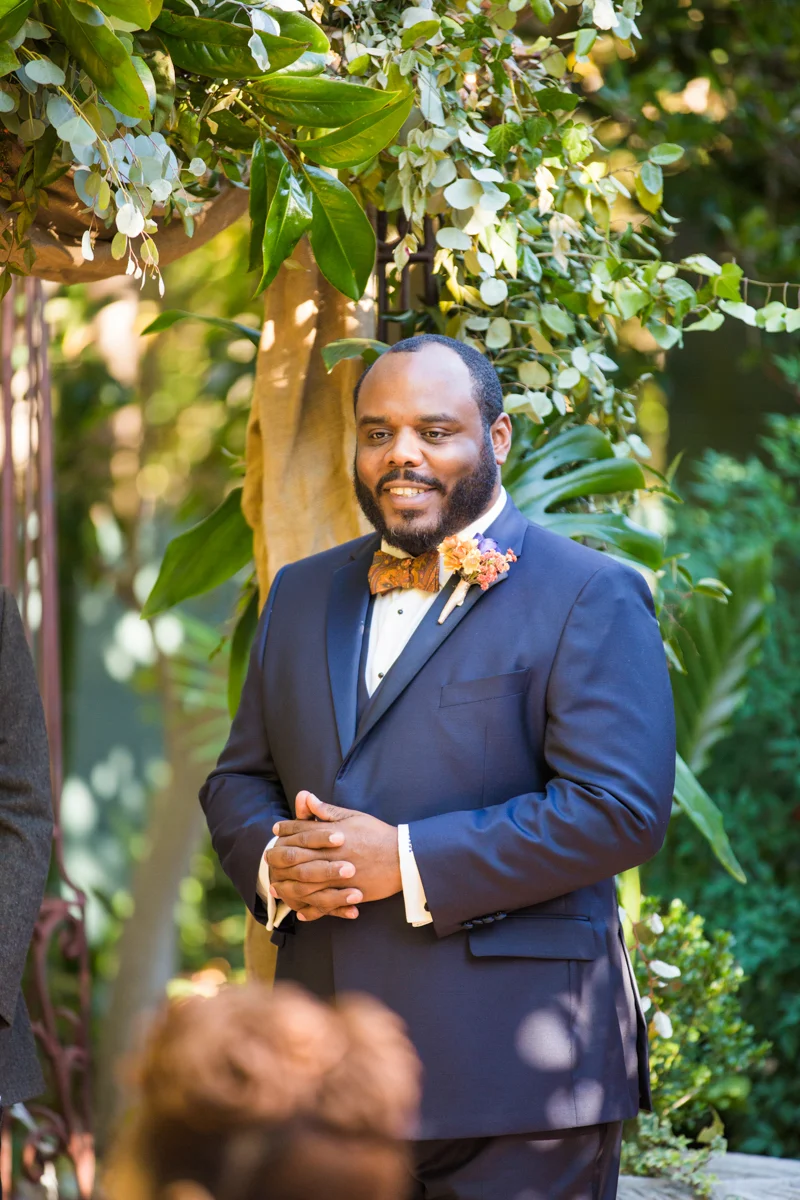 Groom seeing the bride for the first time and smiling