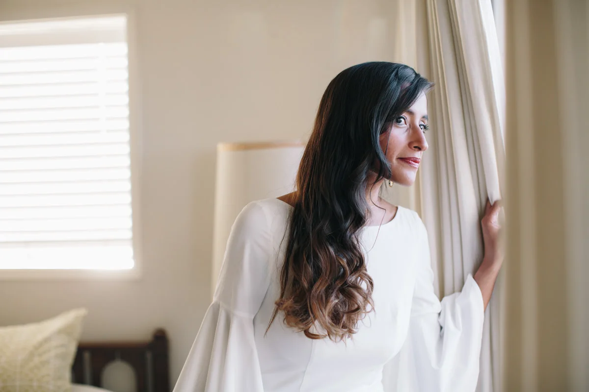Bride looking out at the gathering crowd