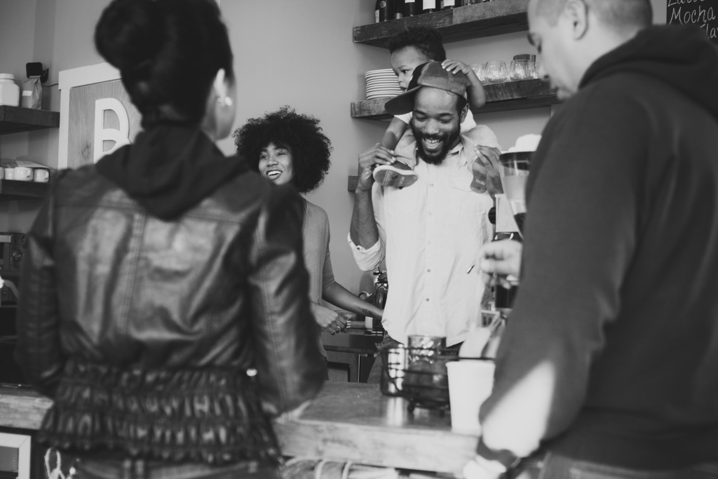 Man with girl on his shoulders behind a store counter with friends Richmond Virginia Toronto Ontario Canada Hidden Exposure Photography