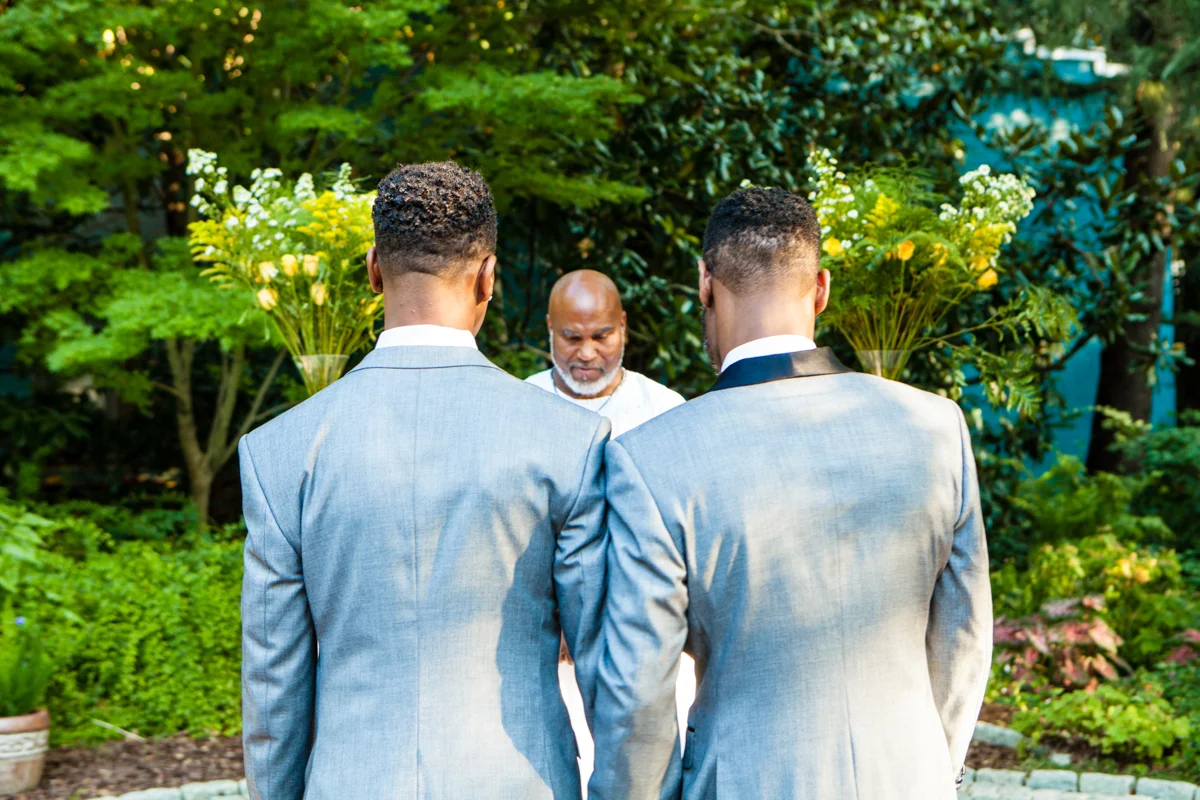 Grooms in bespoke tuxedos at their wedding ceremony
