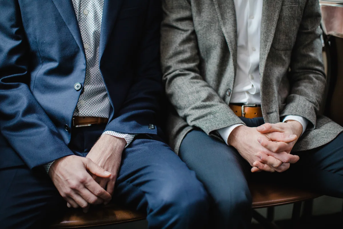 hand and suit detail closeup of gay engagement photos