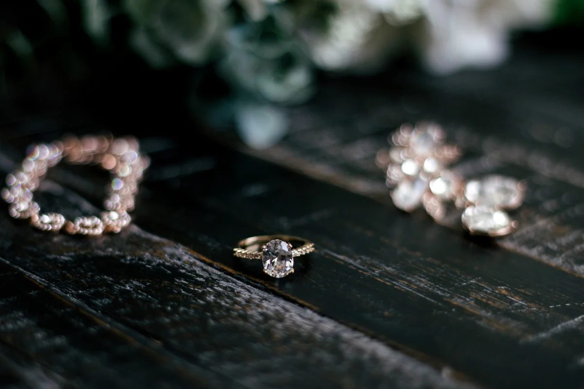 Bride's accessories laid out, including her oval cut ring