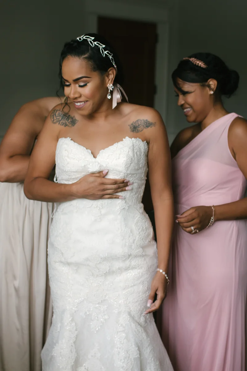Bride being zipped up