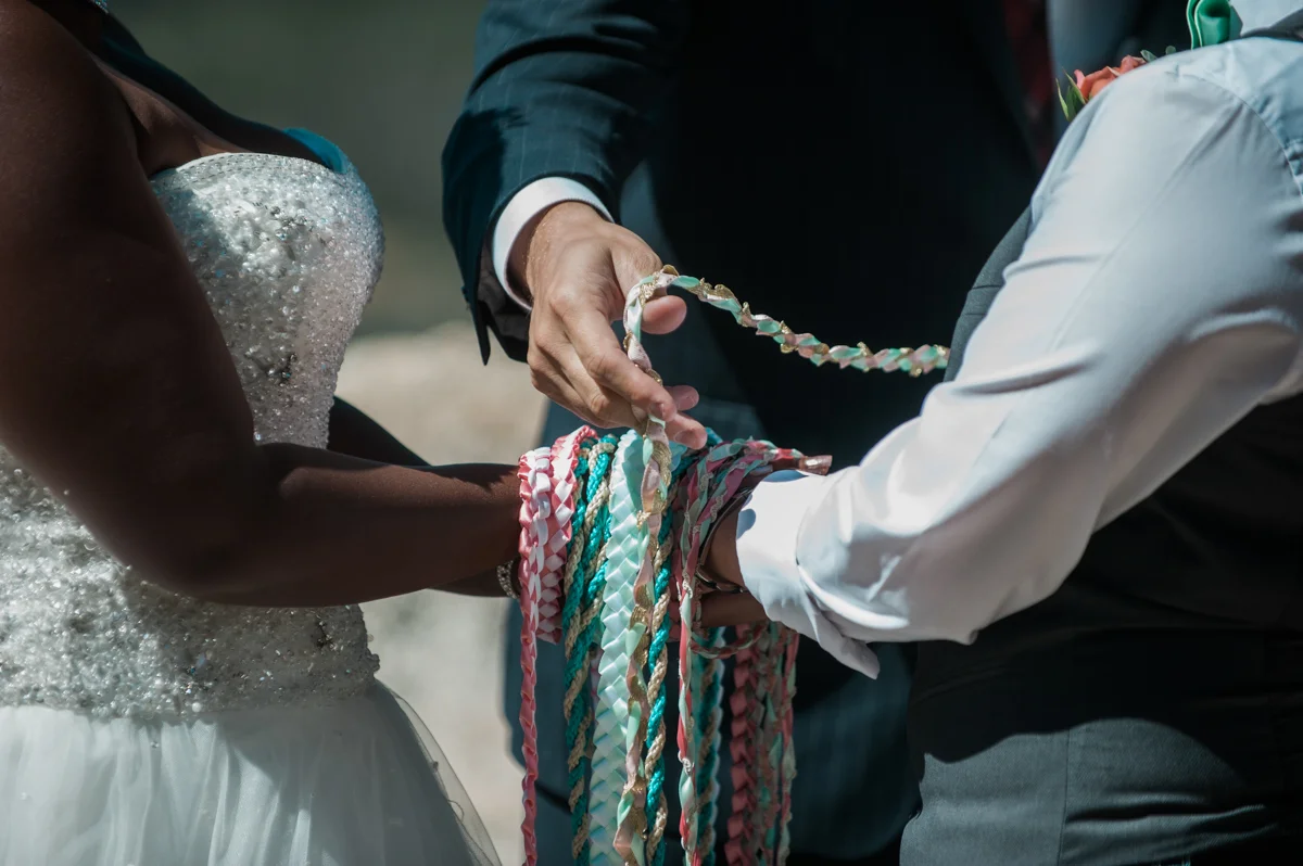 mountain elopement cords on hands