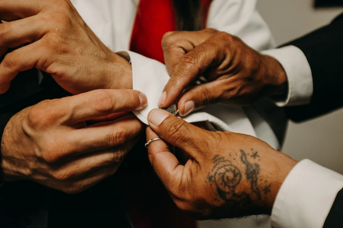 San antonio garden wedding putting on cufflinks