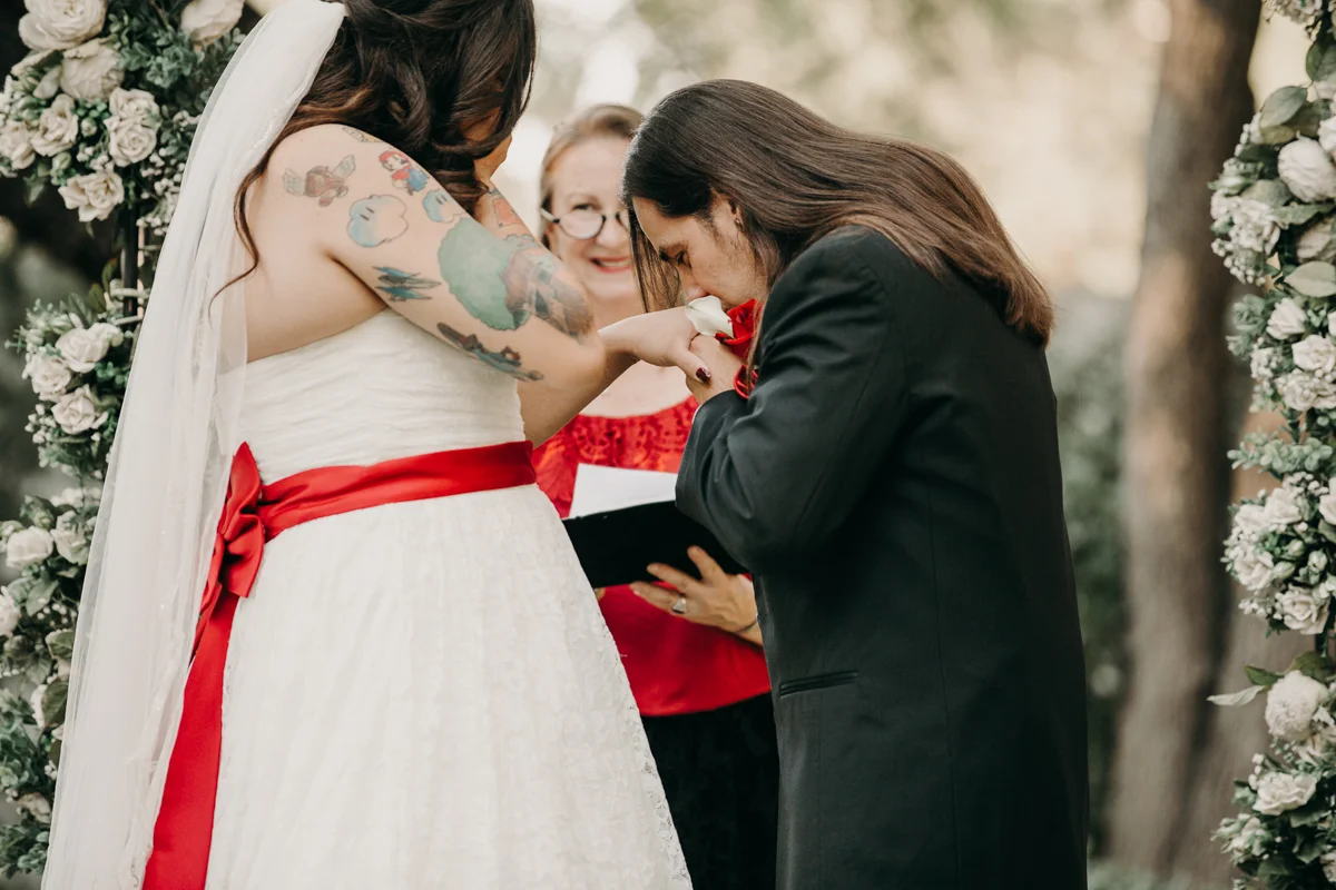 San antonio garden wedding mykel kissing orlando's hand