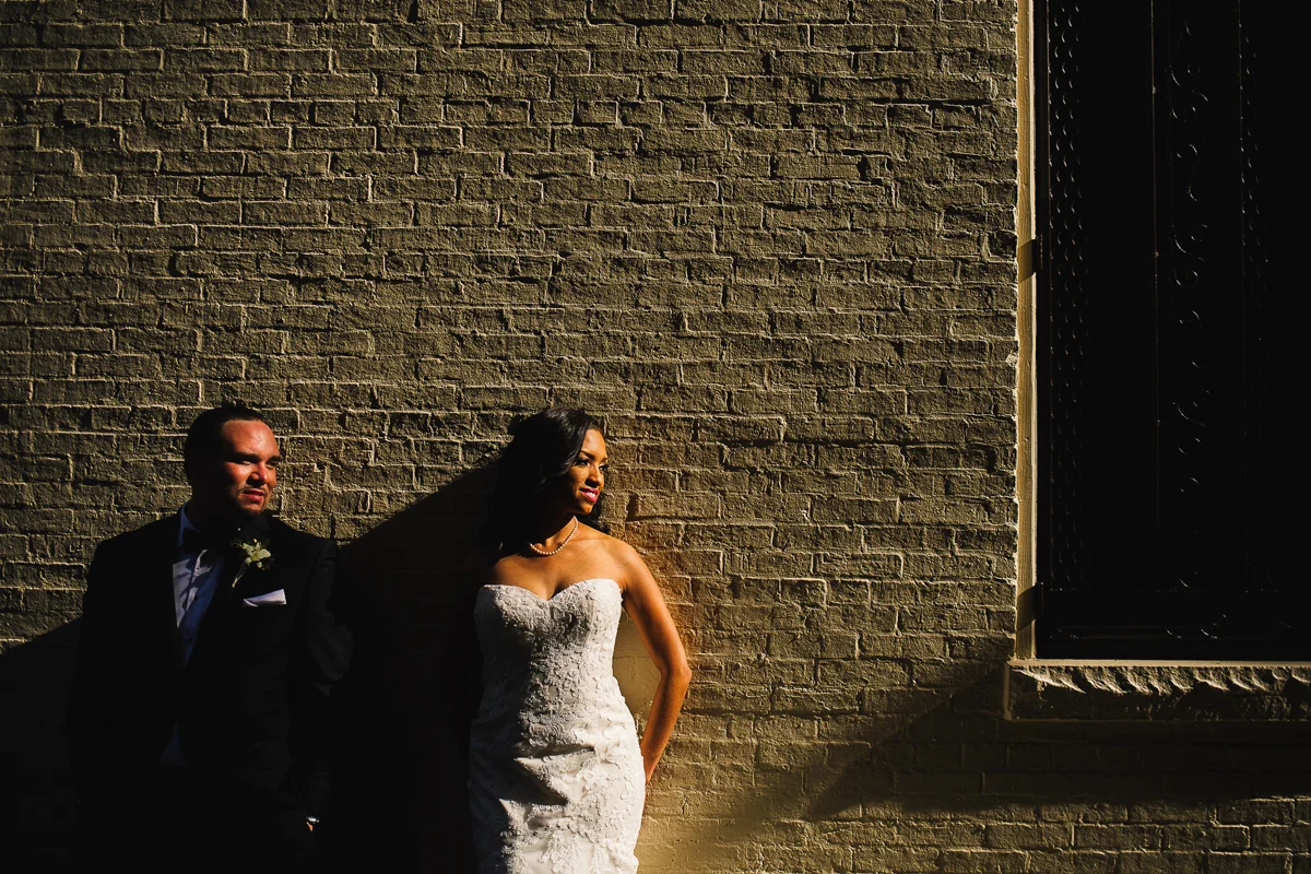 mount vernon ballroom wedding couple leaning against brick wall