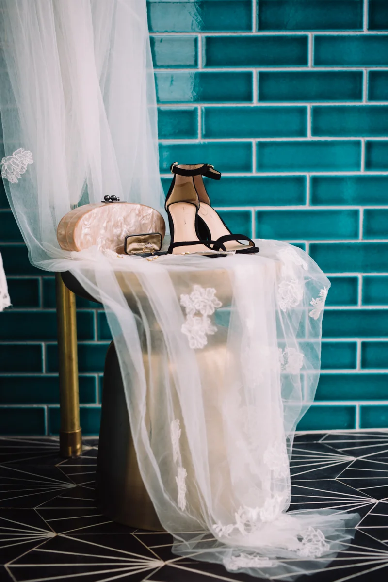 williamsburg hotel wedding shoot bride's shoes and accessories on lace-draped chair