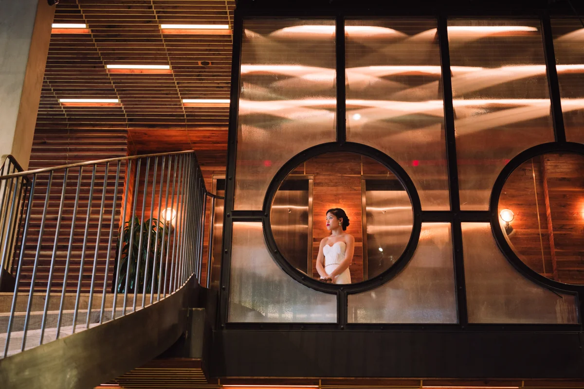 williamsburg hotel wedding shoot bride through circular window