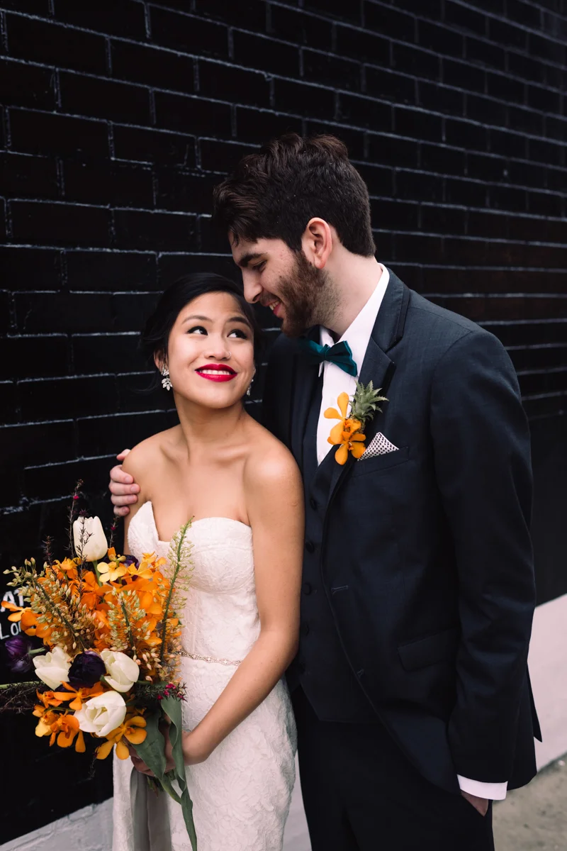 williamsburg hotel wedding shoot couple in front of dark brick