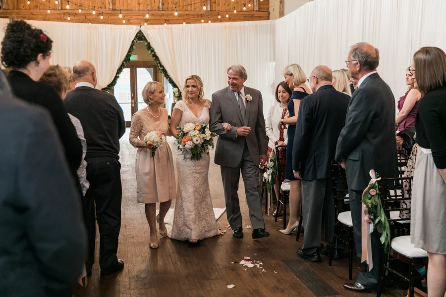 ARIN AND KATIE DOWNTOWN SEATTLE WEDDING katie walking down aisle with parents