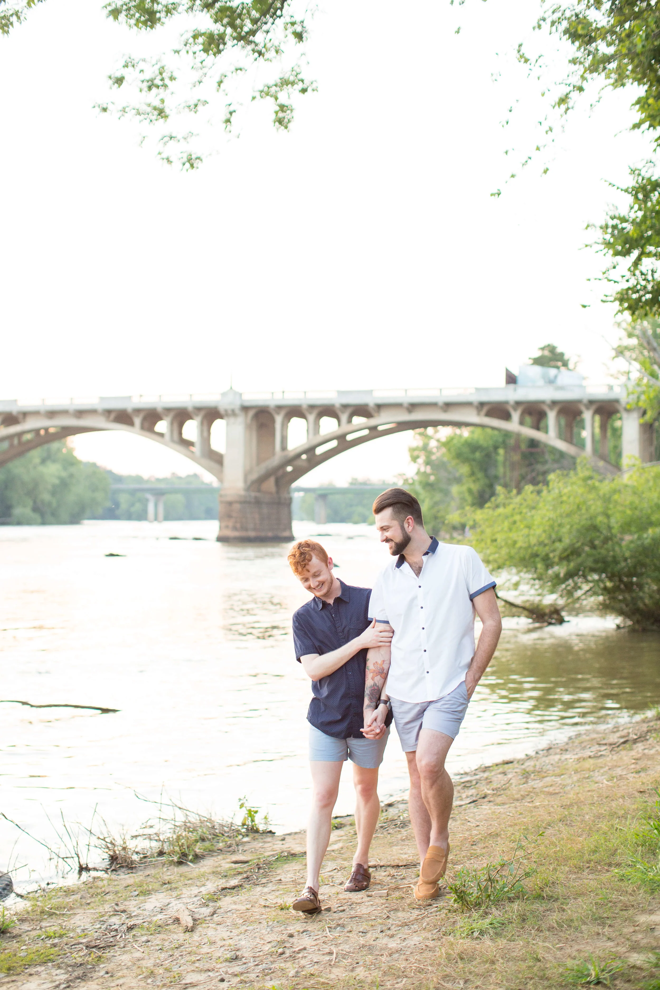 LGBTQ couple holding hands and walking along a river Jessica Hunt Photography Southeast US Weddings