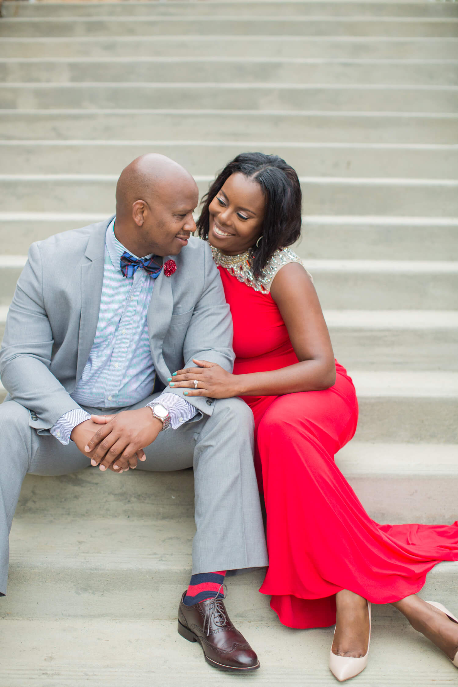 Engaged couple sitting together on stairs Jessica Hunt Photography Southeast US Weddings