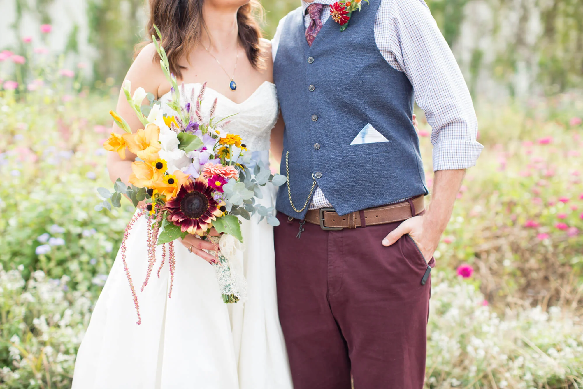Bride and groom posing together with colorful bouquet Jessica Hunt Photography Southeast US Weddings