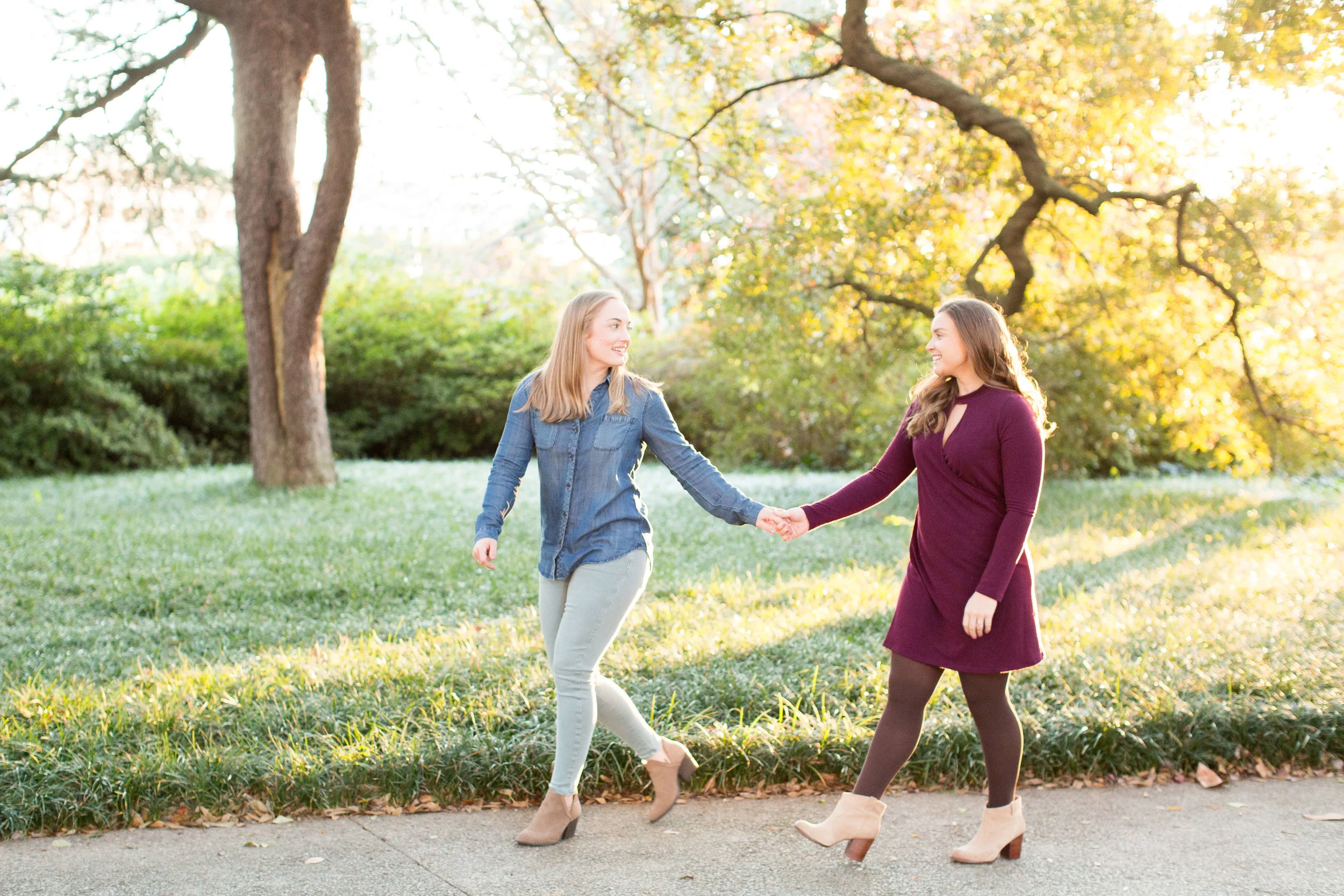Engaged couple holding hands and walking a long a park path Jessica Hunt Photography Southeast US Weddings