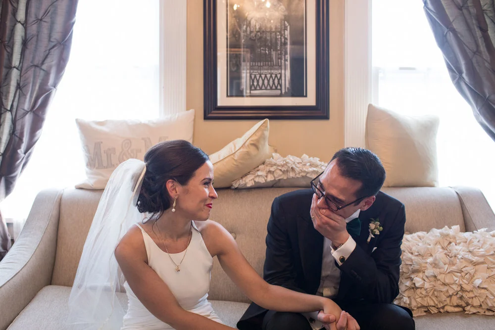 Bride and groom emotionally looking at each other on a couch Missoula Montana Meera Graham Photography