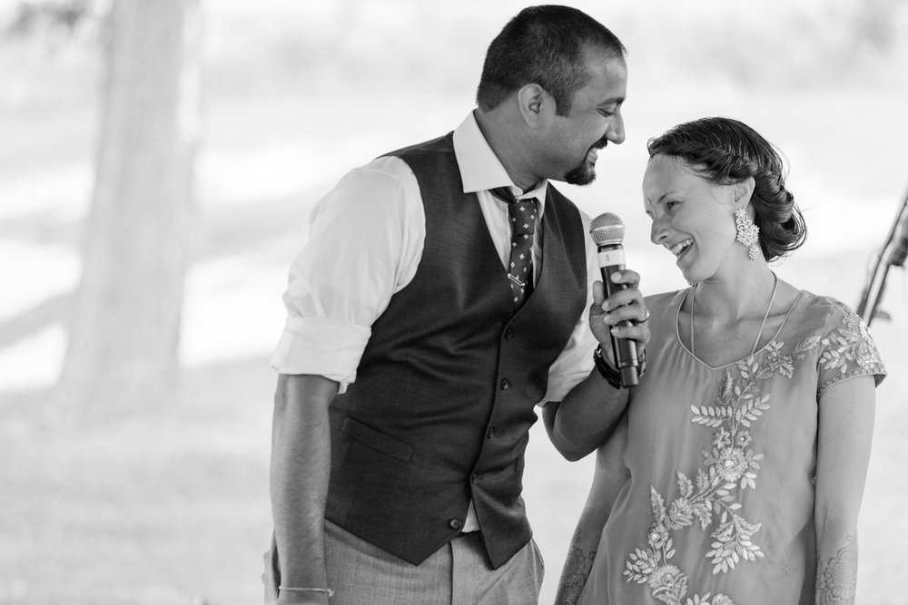 Multicultural newlywed couple giving a speech at their wedding Missoula MT Meera Graham Photography