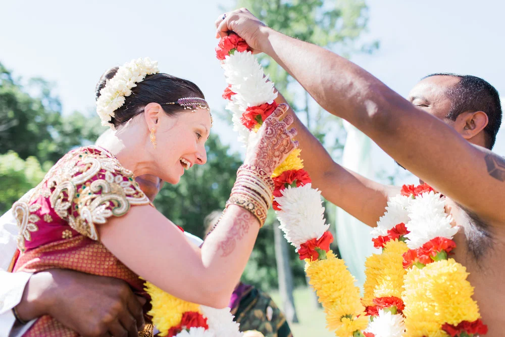 Multicultural bride receiving a floral garland Meera Graham Photography Missoula Montana