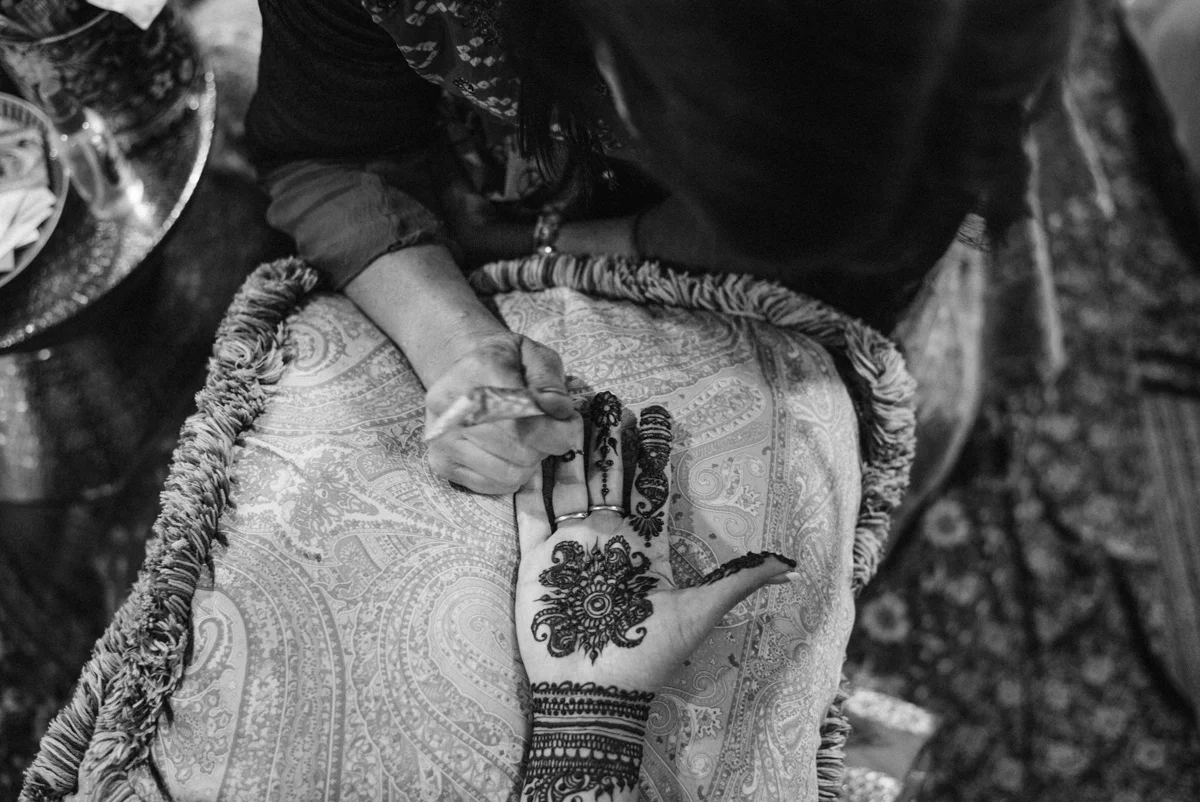 DENVER SAME-SEX INDIAN WEDDING HENNA BEING APPLIED TO BRIDE'S PALM