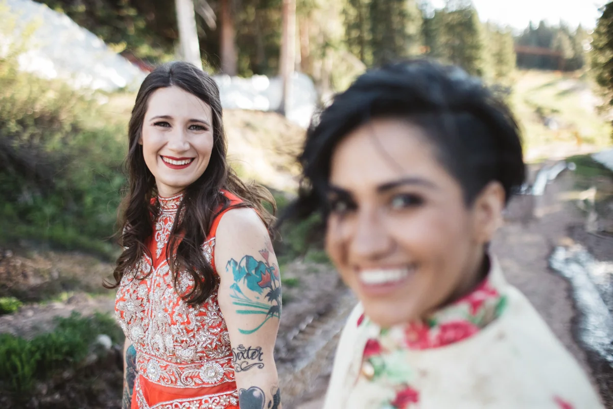 DENVER SAME-SEX INDIAN WEDDING BRIDES SMILING FOR CAMERA, ALBERTINE IN FOCUS
