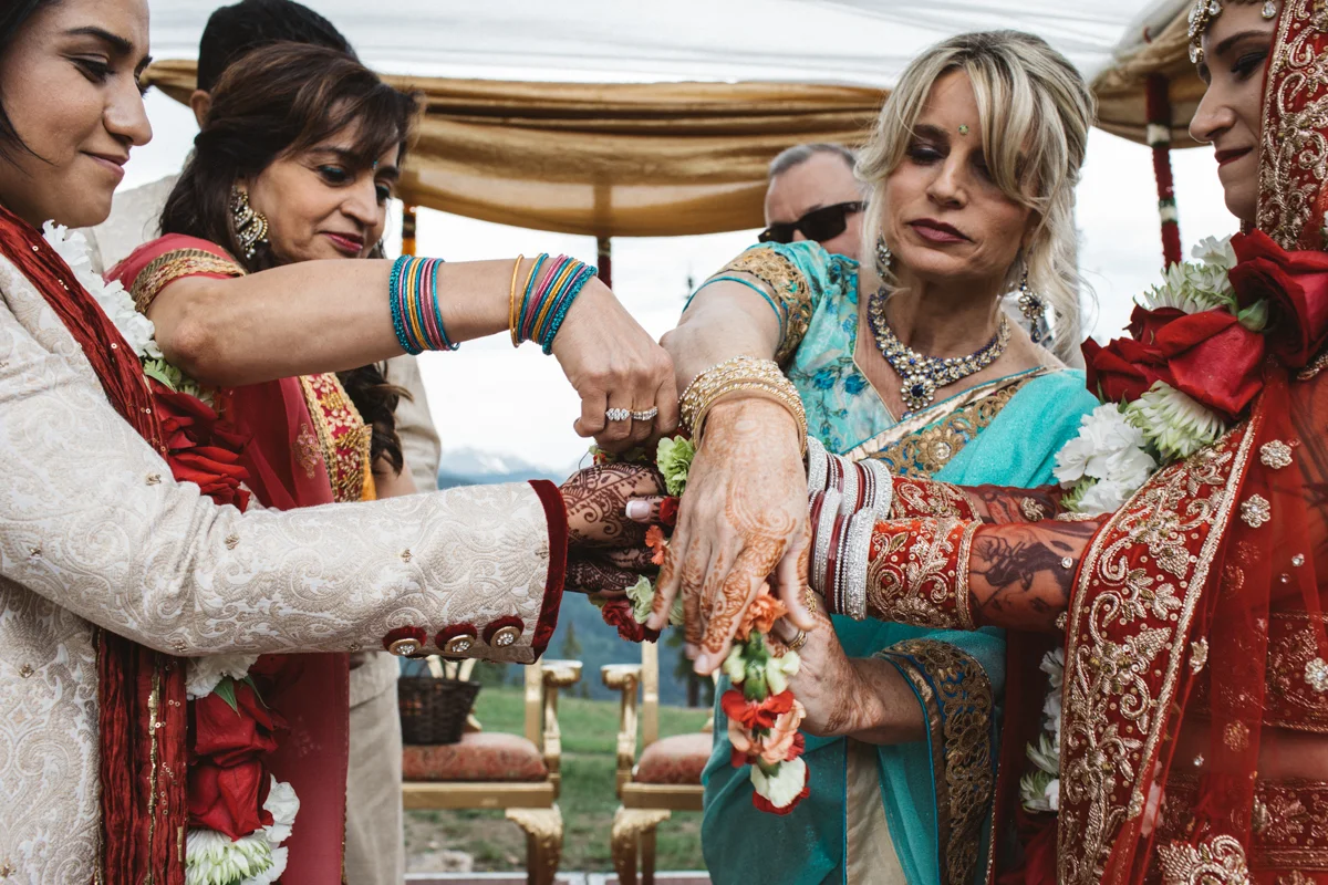 Denver Same-Sex Indian Wedding parents tying hands (kanyaadaan)