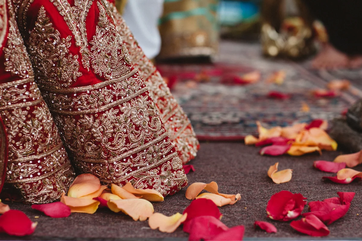 Denver Same-Sex Indian Wedding flower petals on ground with hem of albertine's dress