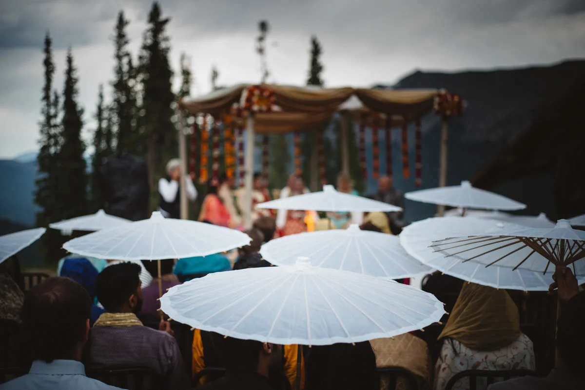 Denver Same-Sex Indian Wedding guests holding paper umbrellas