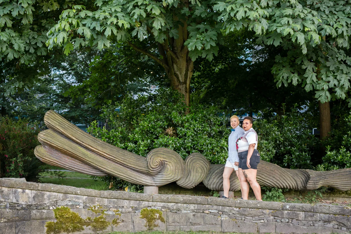 vancouver "just because" photo shoot couple walking in front of park's sculpture