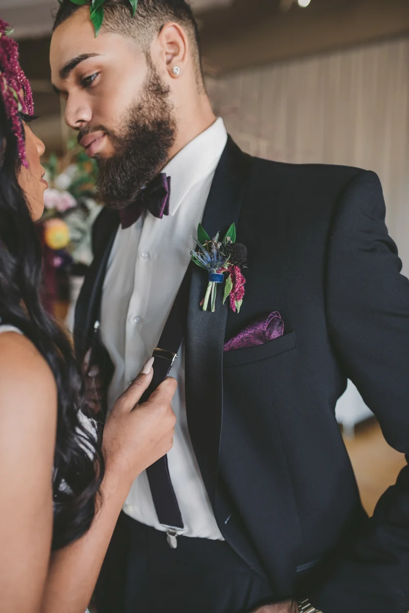 we are young worth the wait studios bride pulling groom closer by suspenders