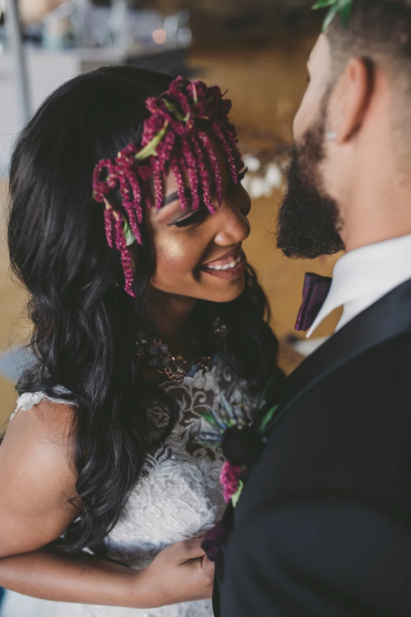 we are young worth the wait studios bride smiling as she pulls groom closer