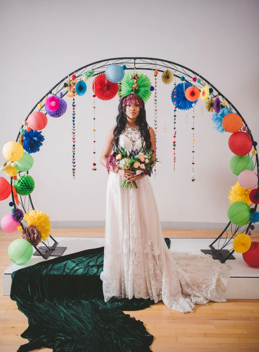 we are young worth the wait studios bride at altar with paper lantern-decorated arch