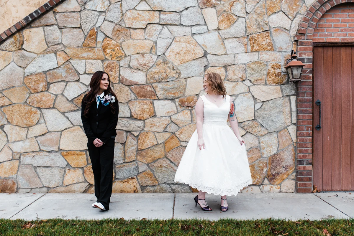 Rustic italian wedding candess and jess in front of italian-style brick