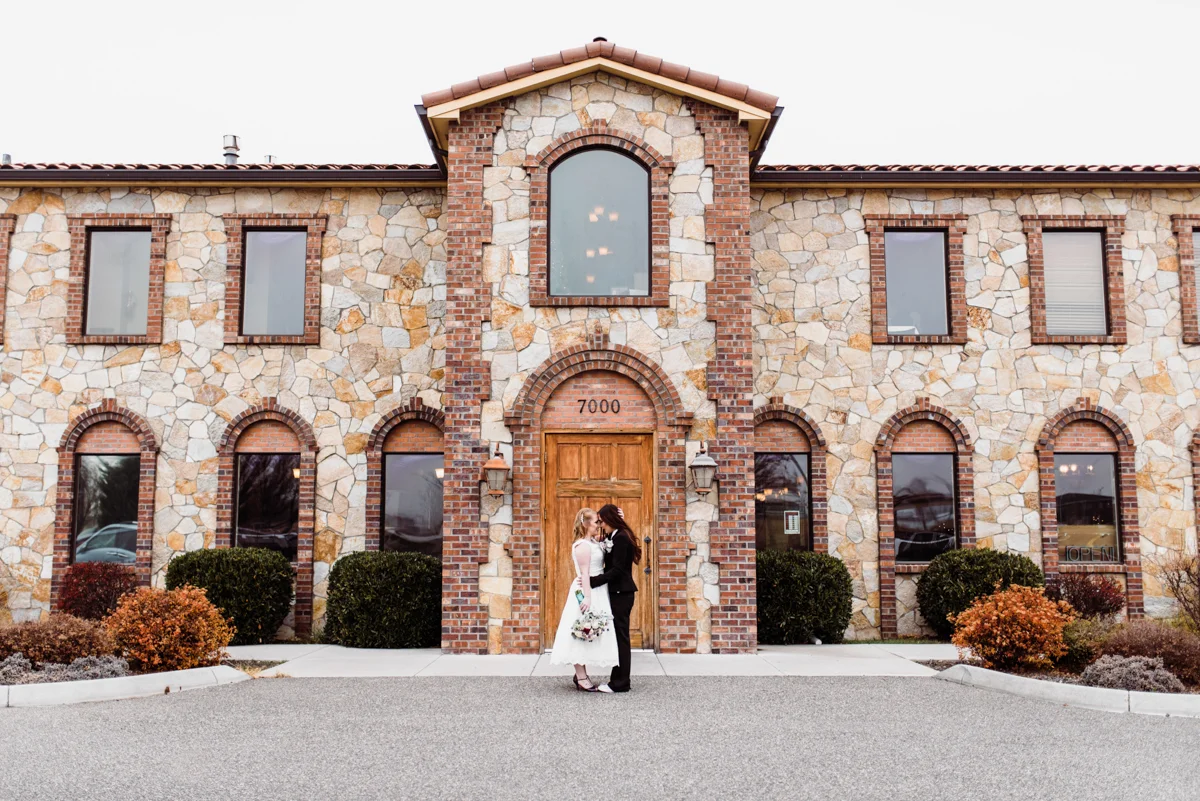 Rustic italian wedding embrace in front of restaurant