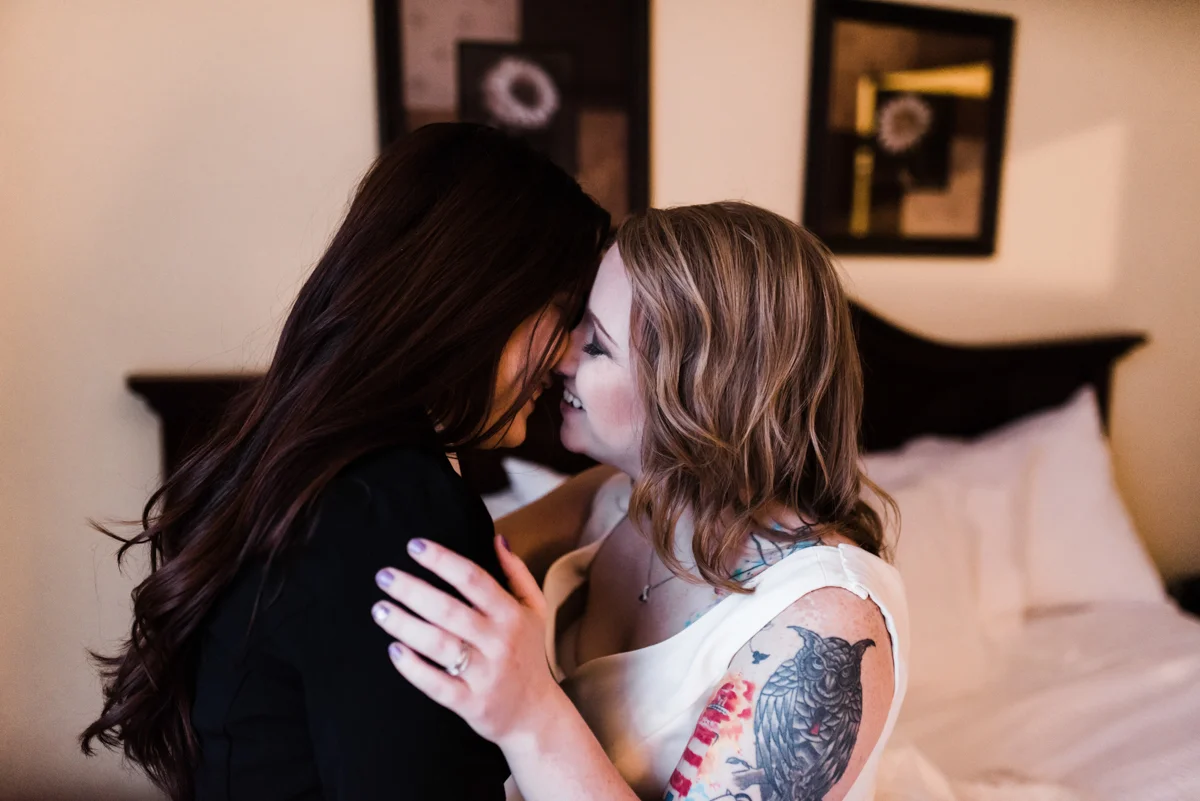 Rustic italian wedding embrace in front of hotel bed