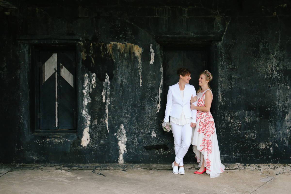 gulf shores destination wedding ajay and kate in front of old wall