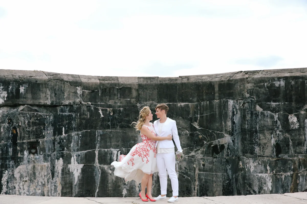 gulf shores destination wedding embrace in front of stone wall