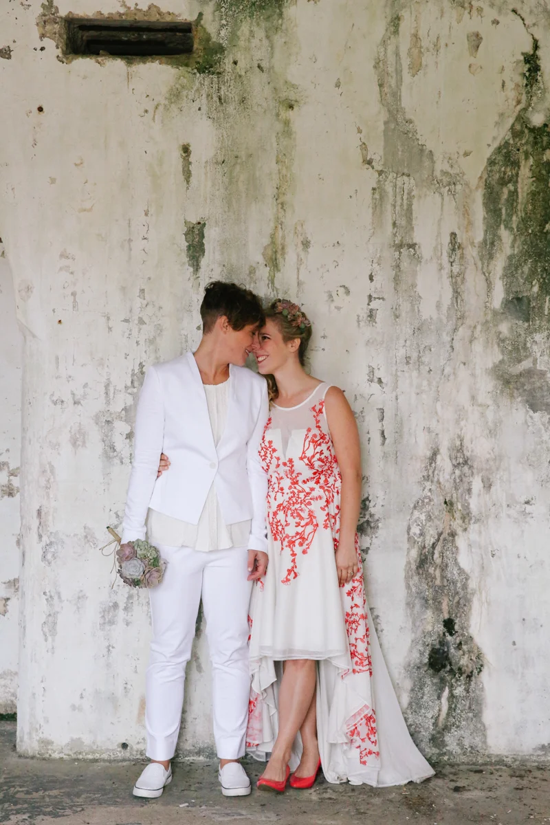 gulf shores destination wedding embrace in front of chipped wall