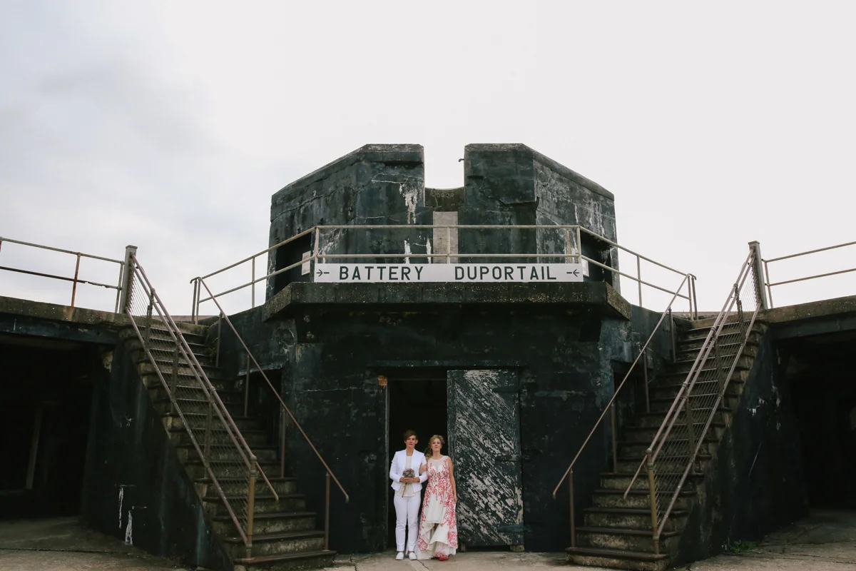 gulf shores destination wedding couple standing under sign reading "battery duportail"