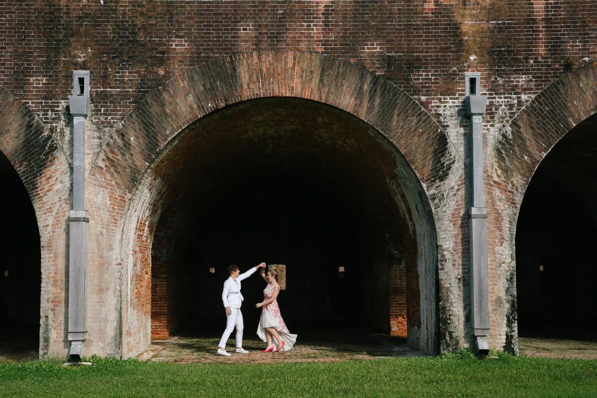 gulf shores destination wedding kate spinning ajay while under brick arch