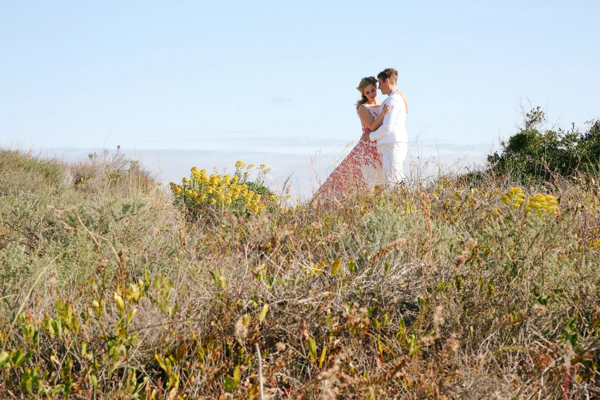 gulf shores destination wedding couple in field overlooking ocean