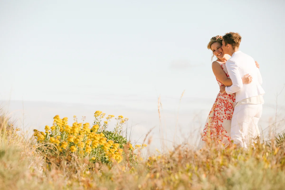 gulf shores destination wedding kate kissing ajay's cheek in field