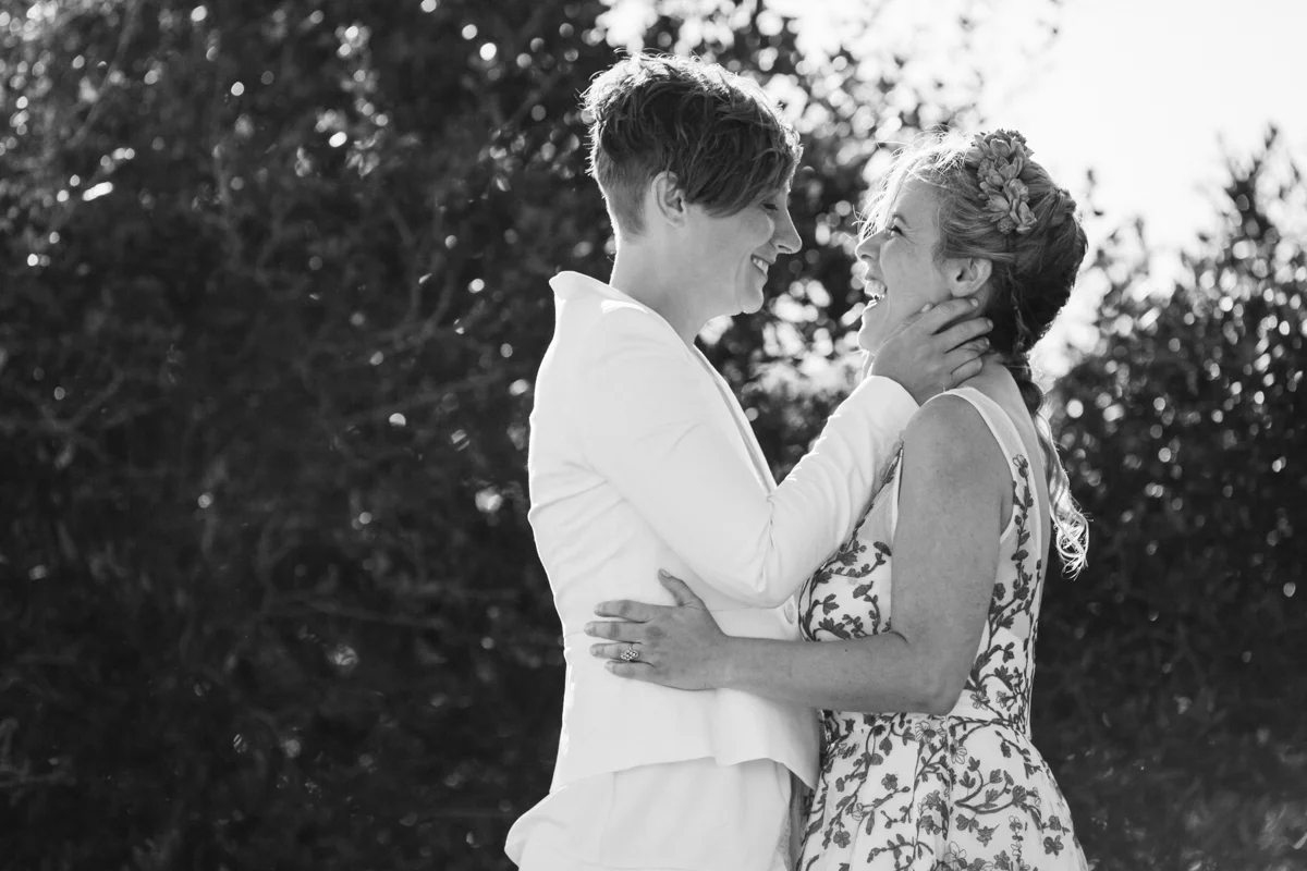 gulf shores destination wedding kate holding ajay's face, ajay laughing