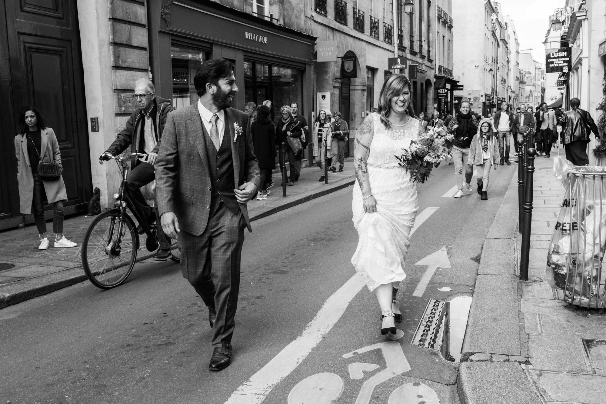 Newlywed couple walking down a oneway street with a crowd of people Corey Torpie Photography NYC