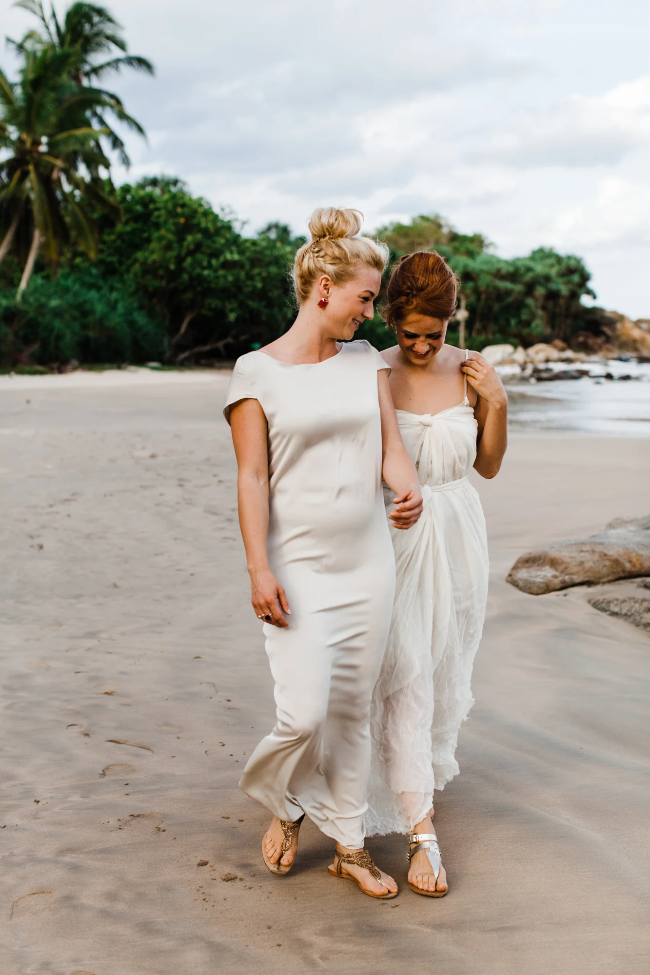Brides holding hands and walking along the beach together Corey Torpie Photography NYC