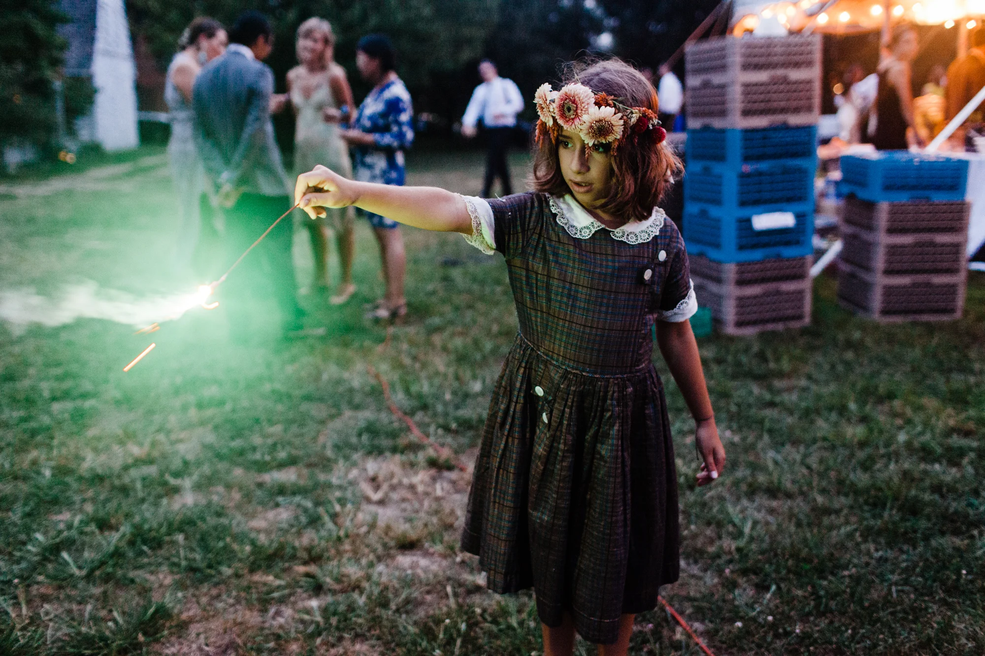 Young girl with flower crown playing with a sparkler at a wedding reception Corey Torpie Photography NYC