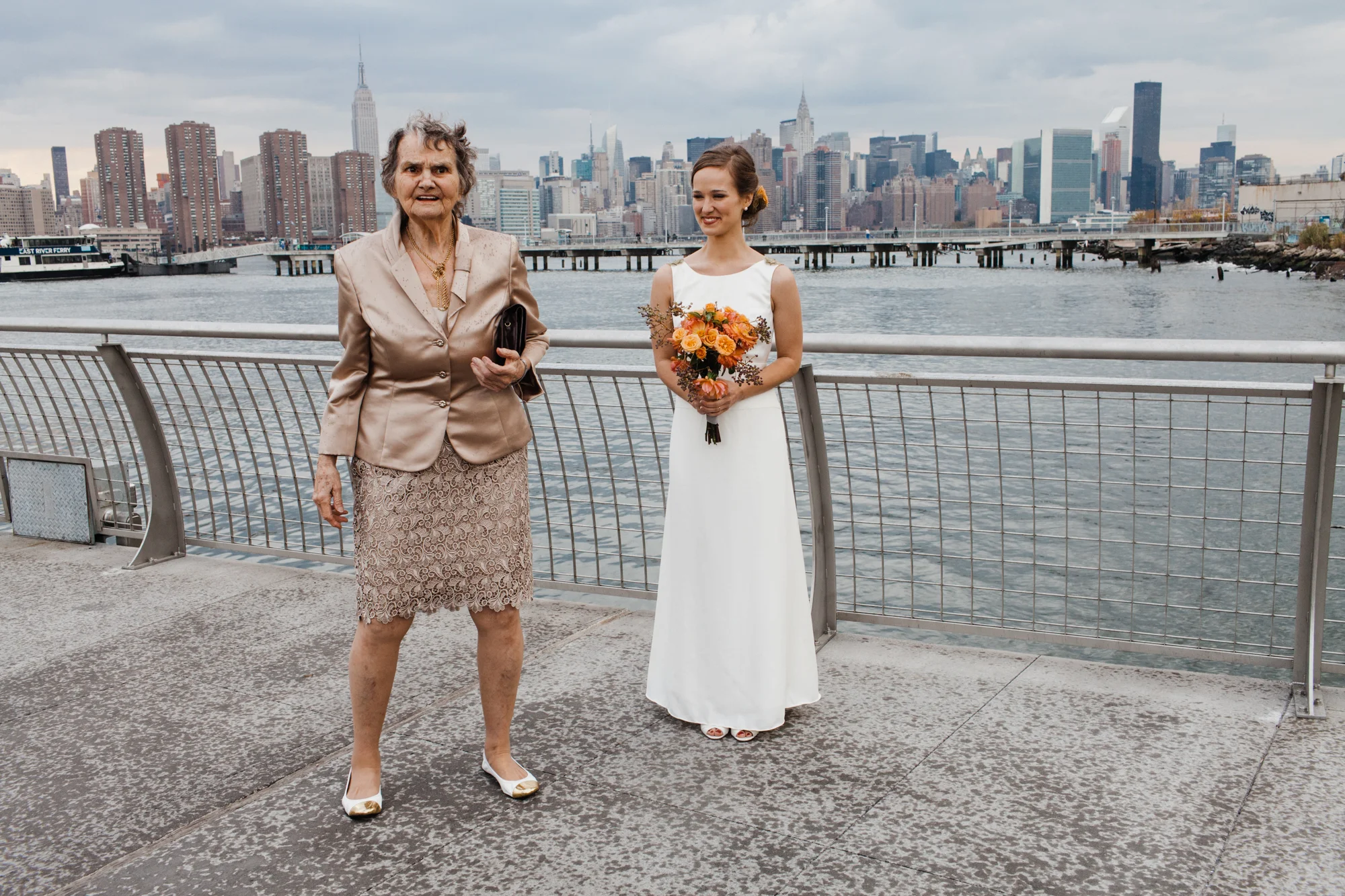 Bride posing with other woman with the NYC skyline Corey Torpie Photography NYC