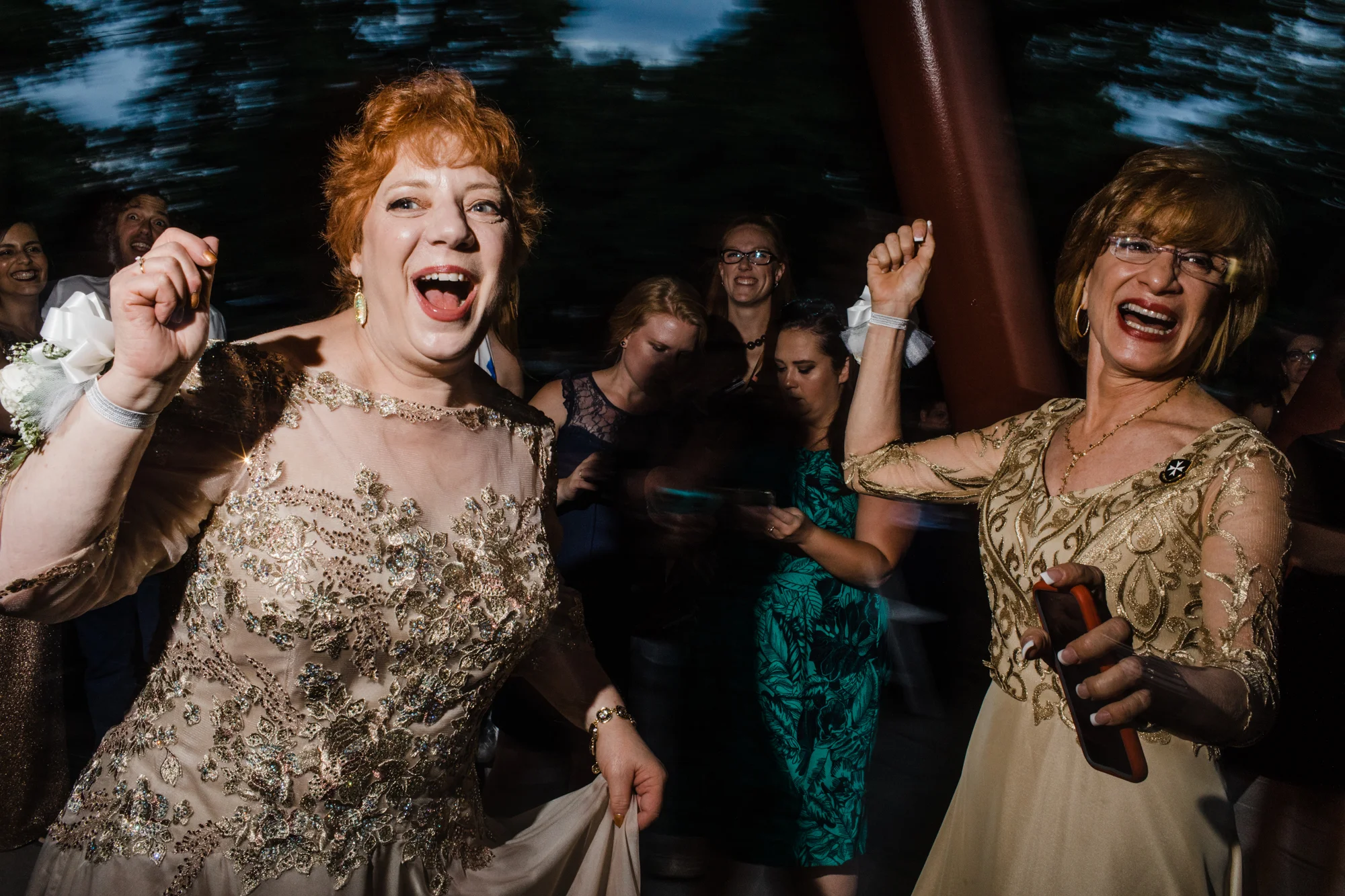 Two older wedding guests dancing in gold and silver lace dresses Corey Torpie Photography NYC