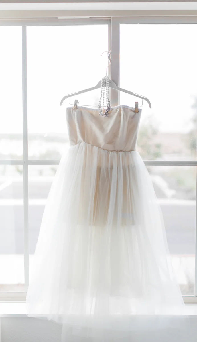 belmont park engagement session san diego dress and necklace hanging in front of window